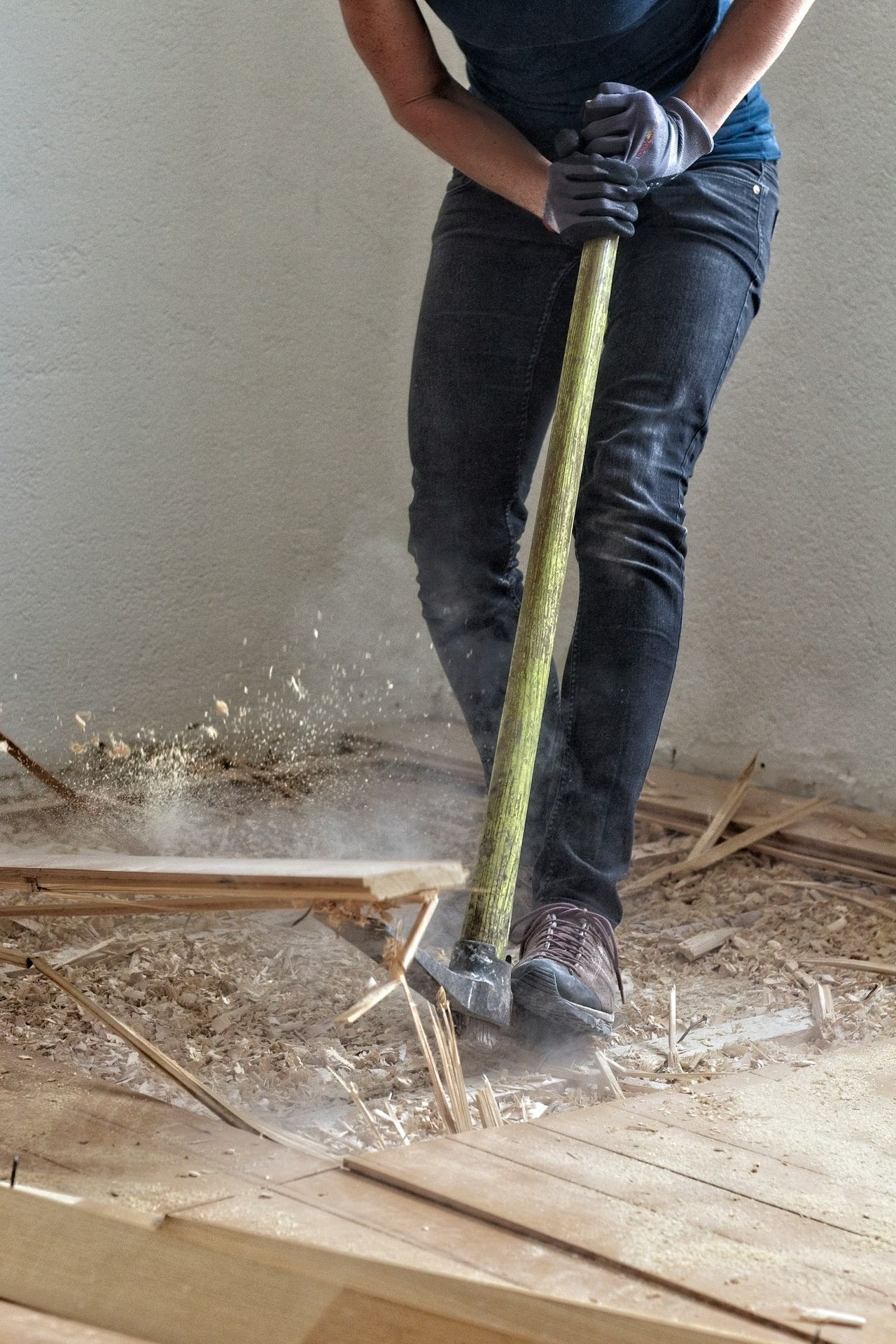 a man holding a large hammer in a room